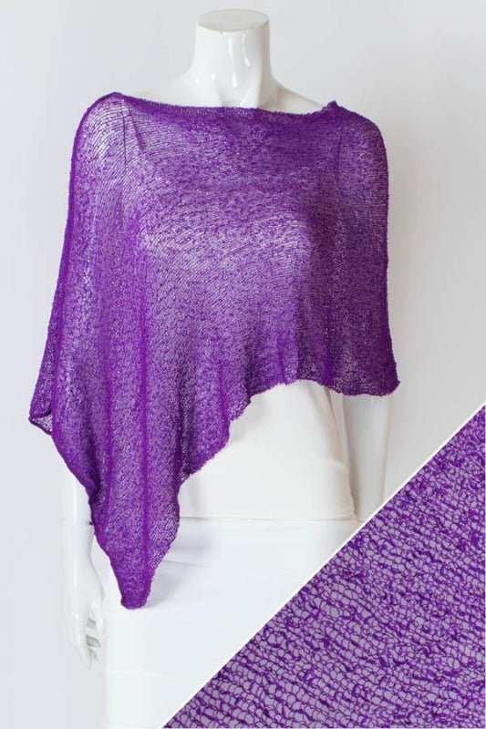 Purple knitted shawl on a mannequin with a white background