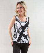 Load image into Gallery viewer, Woman wearing a sleeveless top with abstract black and white design on a plain background
