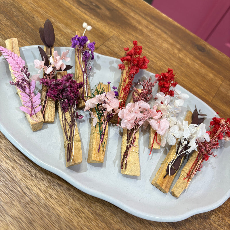 Decorative Palo Santo Sticks with dried flowers flowers wrapped in gold wire.
