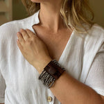 Load image into Gallery viewer, Person wearing a gunmetal beaded  bracelet on a blurred indoor background
