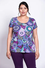 Load image into Gallery viewer, Woman wearing a colorful patterned shirt on a white background
