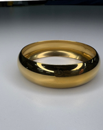 Load image into Gallery viewer, Gold bracelet on a light gray background
