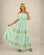 Load image into Gallery viewer, Woman wearing a light green lace dress against a plain background
