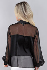 Load image into Gallery viewer, Woman wearing a black and sheer chiffon blouse against a gray background
