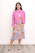 Load image into Gallery viewer, Woman wearing a pink jacket over a floral dress on a plain background
