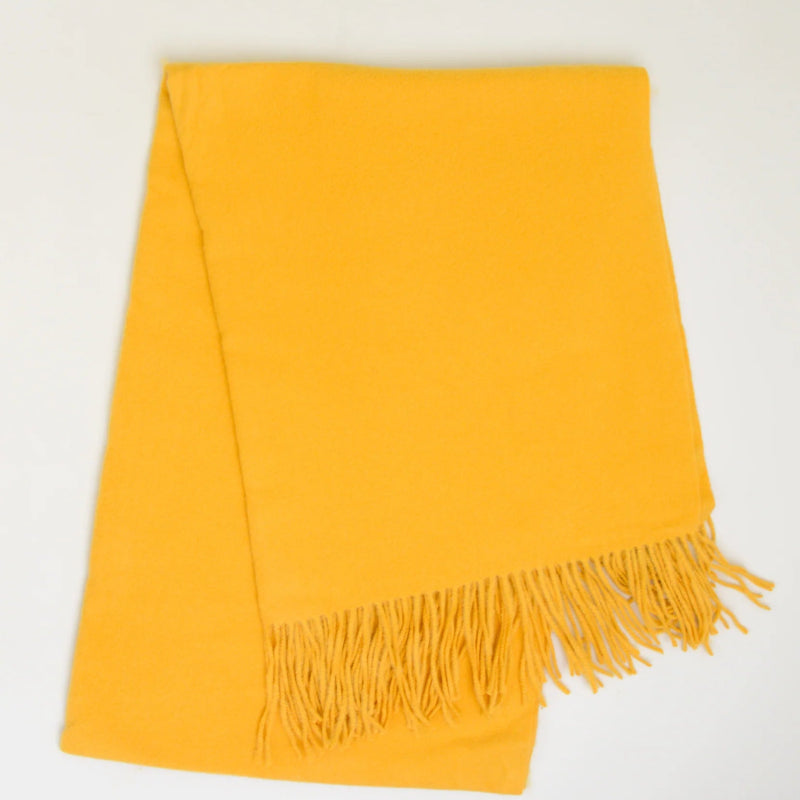 Yellow scarf with fringes on a white background