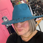 Load image into Gallery viewer, Person wearing a blue wide-brimmed suede hat with decorative patterns indoors.
