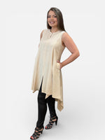 Load image into Gallery viewer, Woman wearing a beige sleeveless tunic dress and black faux leather leggings on a white background
