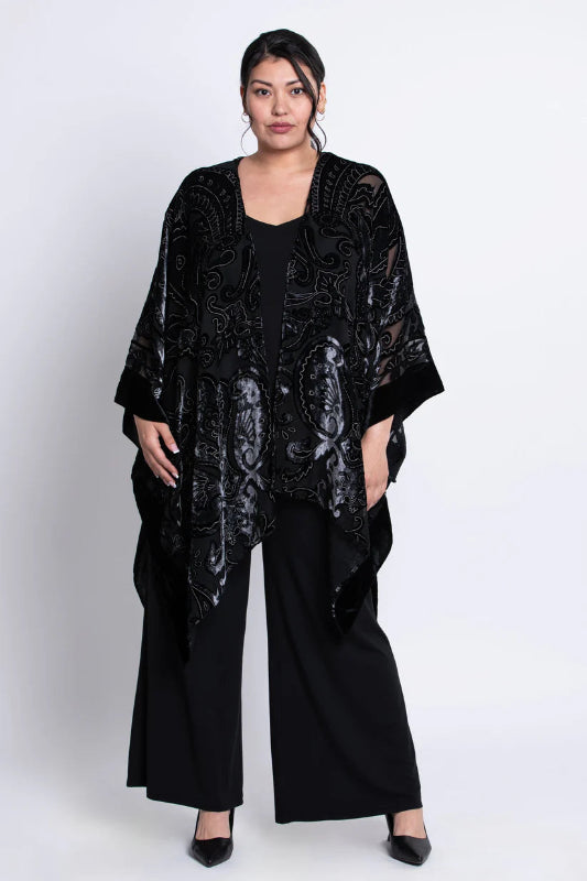 Woman wearing a black velvet patterned kimono on a white background