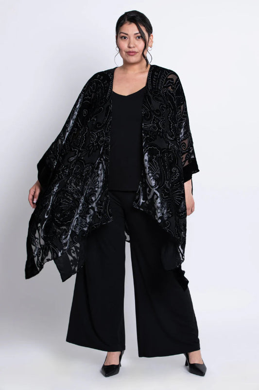 Woman wearing a black velvet patterned kimono on a white background