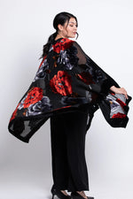 Load image into Gallery viewer, Woman wearing a black velvet
 kimono with red and white patterns on a white background
