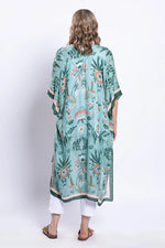 Load image into Gallery viewer, Woman wearing a green floral kimono-style garment on a white background
