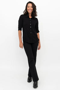 Woman wearing a black outfit on a white background