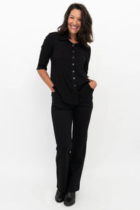 Woman wearing a black outfit on a white background