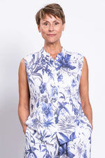 Load image into Gallery viewer, Woman wearing a sleeveless floral dress with blue and white pattern on a plain background
