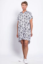 Load image into Gallery viewer, Woman wearing a floral dress against a white background
