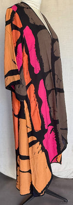 Load image into Gallery viewer, Colorful abstract patterned fabric draped over a mannequin against a white background
