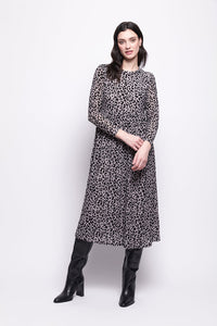 Woman wearing a grey mesh with velvet leopard print dress with black boots on a white background