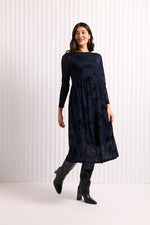 Load image into Gallery viewer, Woman wearing a dark blue  mesh and velvet dress with long sleeves, standing against a white background.
