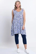 Load image into Gallery viewer, Woman wearing a sleeveless blue and white patterned dress with navy leggings on a white background
