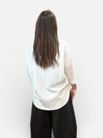 Load image into Gallery viewer, Person wearing a white blouse with black pants against a white background
