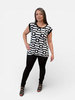 Load image into Gallery viewer, Woman wearing a black and white geometric patterned top on a white background

