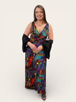 Load image into Gallery viewer, Woman wearing a colorful dress with black gloves on a white background
