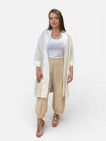 Load image into Gallery viewer, Woman wearing a white top, beige pants, and a long white cardigan on a white background
