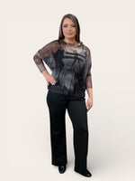 Load image into Gallery viewer, Woman wearing a black and gray sheer top with black pants on a white background
