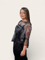 Load image into Gallery viewer, Woman wearing a sheer black top with a white background
