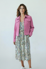 Load image into Gallery viewer, Woman wearing a pink jacket over a patterned dress on a white background
