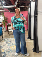 Load image into Gallery viewer, Person taking a mirror selfie wearing a tie-dye shirt and jeans in an indoor setting.
