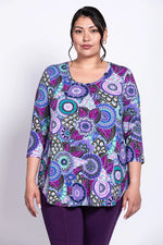 Load image into Gallery viewer, Woman wearing a colorful patterned top on a white background
