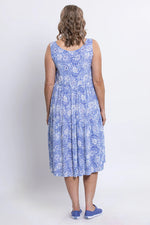 Load image into Gallery viewer, Woman wearing a blue floral dress against a white background
