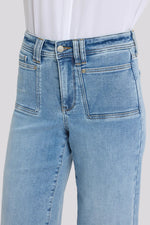 Load image into Gallery viewer, Light blue jeans on a white background
