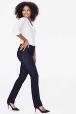 Load image into Gallery viewer, A woman modeling dark wash straight leg  jean.
