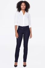 Load image into Gallery viewer, A woman modeling dark RINSE straight leg  jeans .
