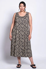 Load image into Gallery viewer, Woman wearing a sleeveless dress with a floral pattern on a white background
