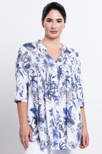 Load image into Gallery viewer, Woman wearing a blue and white floral blouse on a plain background
