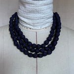 Load image into Gallery viewer, Navy blue beaded necklace on a mannequin with a white background
