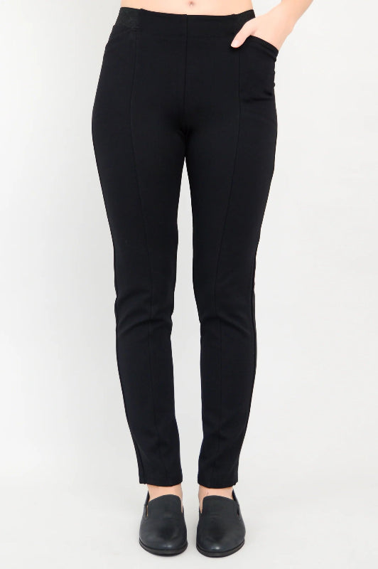 Black pants worn by a person on a white background