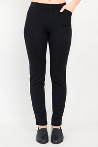 Black pants worn by a person on a white background