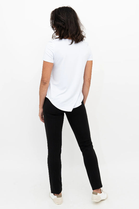 Person wearing a white t-shirt and black pants on a white background
