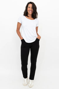 Woman wearing a white t-shirt and black pants on a white background