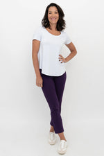 Load image into Gallery viewer, Woman wearing a white top and purple pants on a white background
