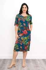 Load image into Gallery viewer, Woman wearing a colorful floral dress against a white background
