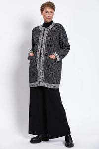 Woman wearing a black and white patterned cardigan 100% Cotton
