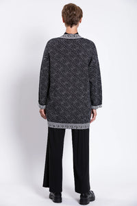 Woman wearing a black and white patterned cardigan 100% Cotton
