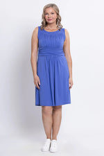 Load image into Gallery viewer, Woman wearing a blue dress against a white background
