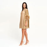 Load image into Gallery viewer, Woman wearing a beige dress with a floral accessory on a white background
